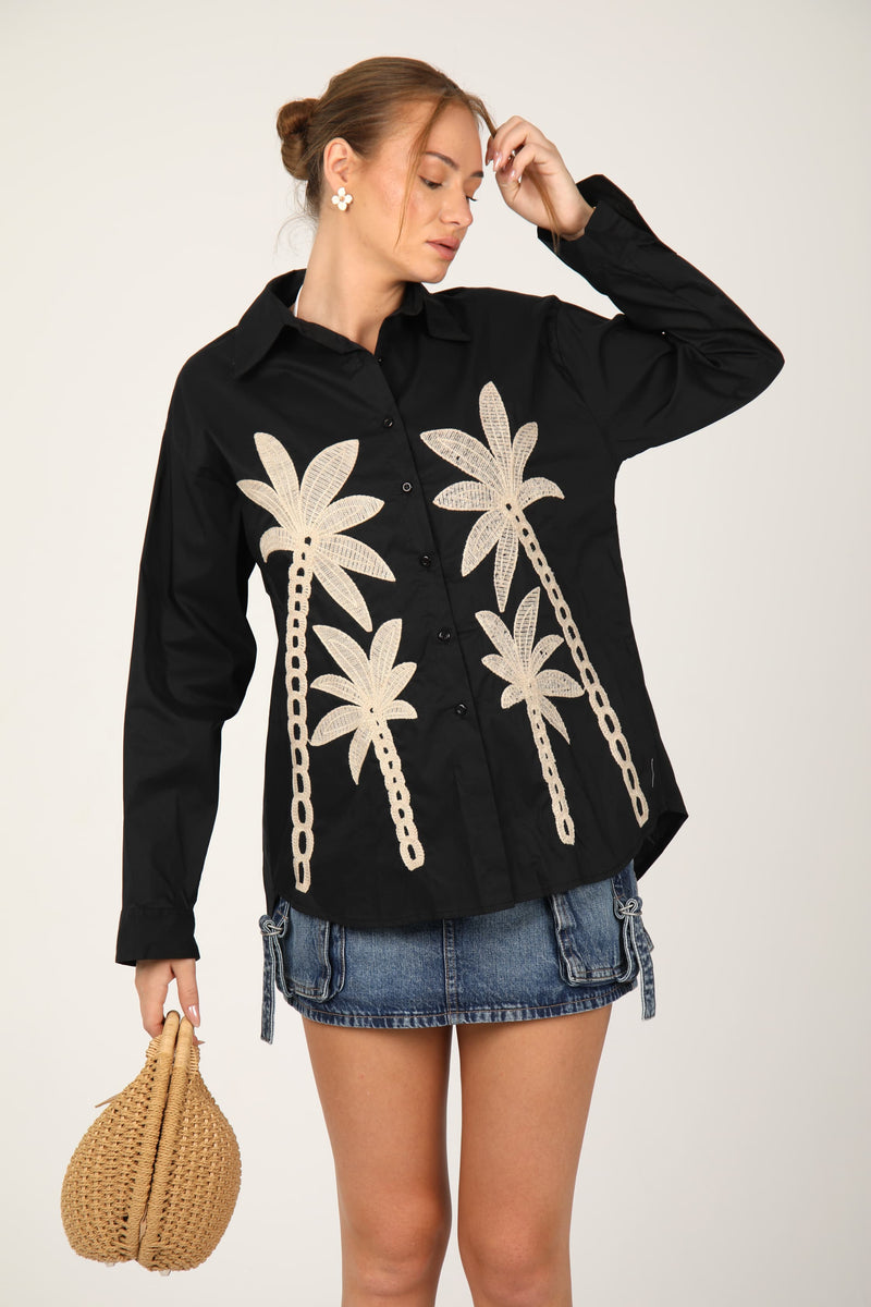 This shirt with palm tree embroidery gives off a fresh, tropical vibe perfect for summer days