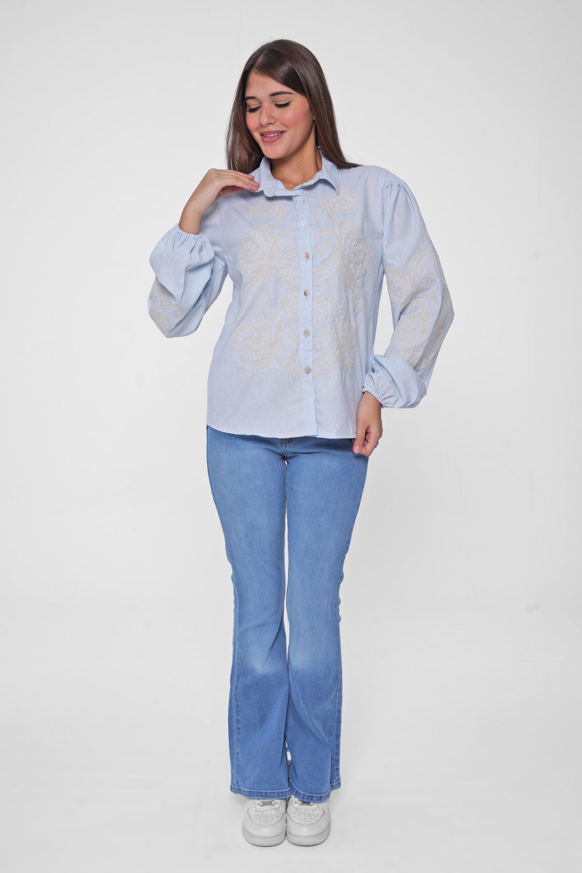 This embroidered shirt blends bohemian charm with modern flair, perfect for adding a statement to your everyday look