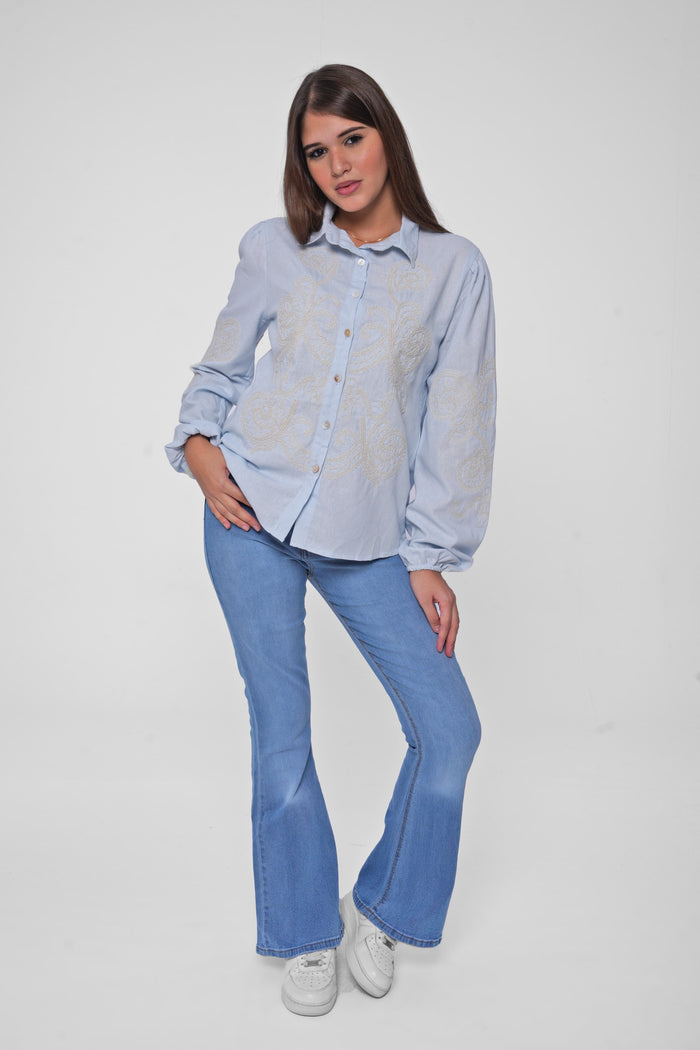 This embroidered shirt blends bohemian charm with modern flair, perfect for adding a statement to your everyday look