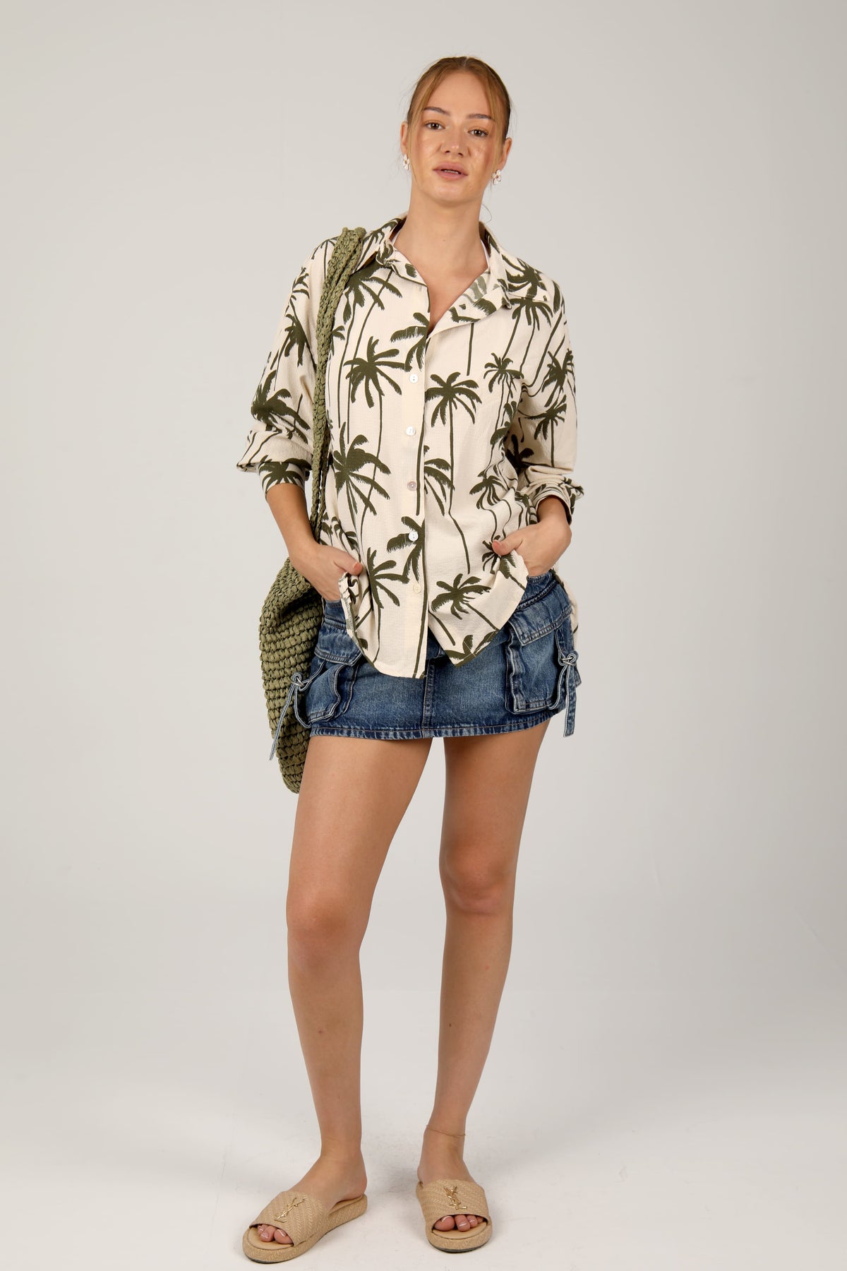 This cream shirt with green palm tree prints offers a relaxed and breezy tropical look, ideal for laid-back summer outings