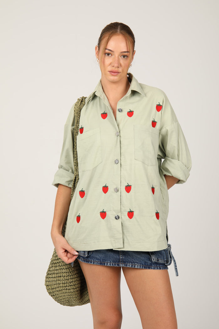 Casual shirt adorned with red strawberry embroidery for a fresh and playful look