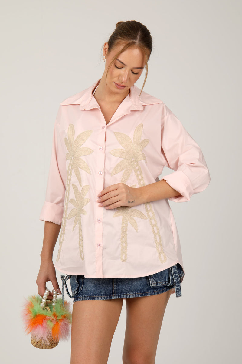 This shirt with palm tree embroidery gives off a fresh, tropical vibe perfect for summer days