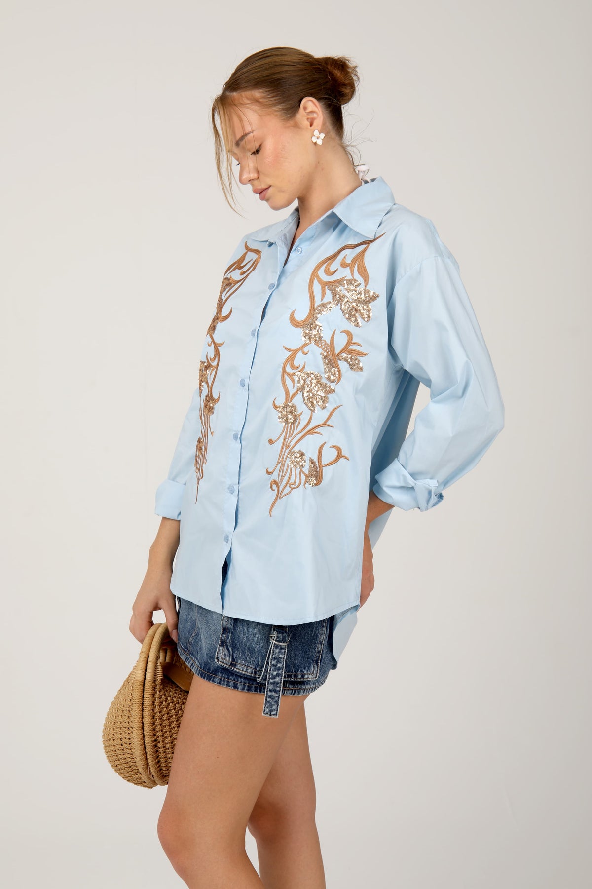 This  shirt with golden embroidery brings a touch of elegance and charm to your casual style.